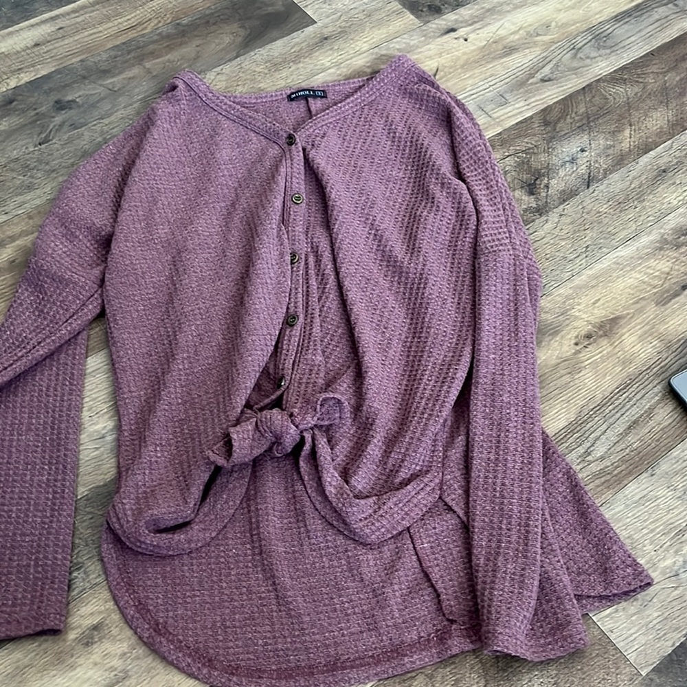 purple button sweater with a tie and the bottom v cut